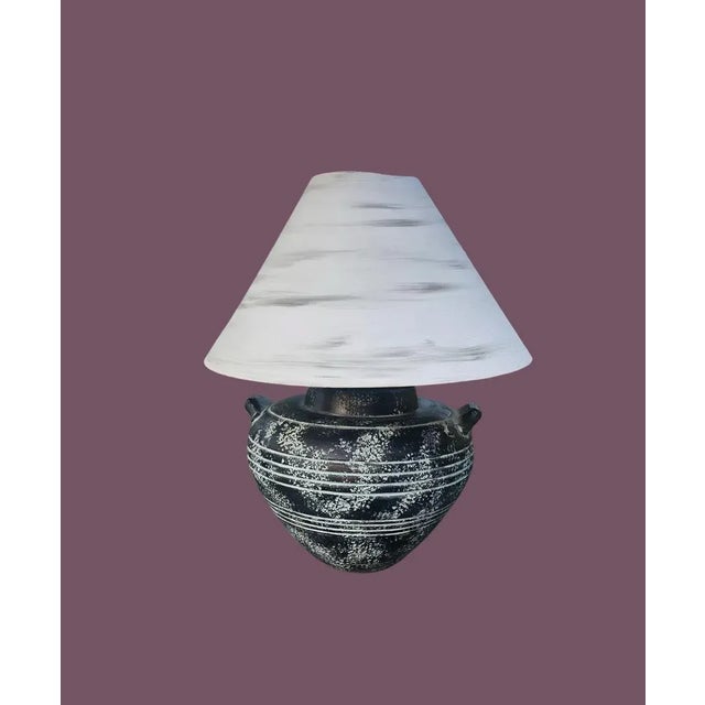 Vintage Automax New York lamp. Features a fat belly urn, that’s short with handles, black and pitted glaze with bronze...