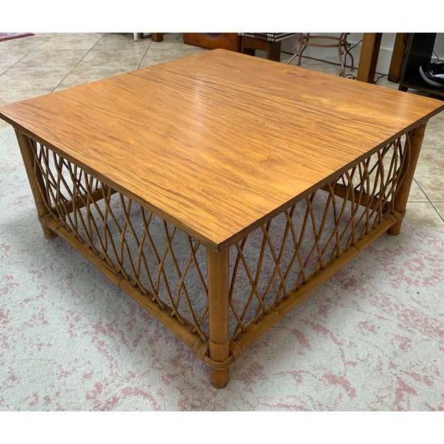 Beautiful vintage coffee table made in the Philippines, featuring a warm wood-tone rectangular/square top and an intricate...