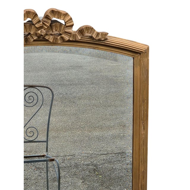 The product is a vintage 1920 French gilded Beveled edge mirror, featuring a rectangular shape and a gold frame finish...