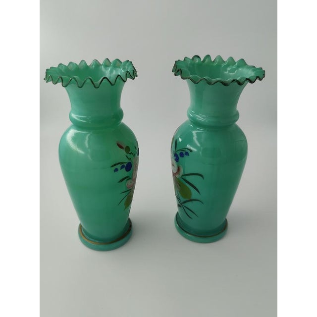 The vases date from the second half of the 19th century. They are made of turquoise opalescent glass and hand-painted with...