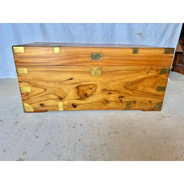 This 19th Century English Camphor Wood Campaign Chest dates back to the late 1800's. The piece features brass mounts and...