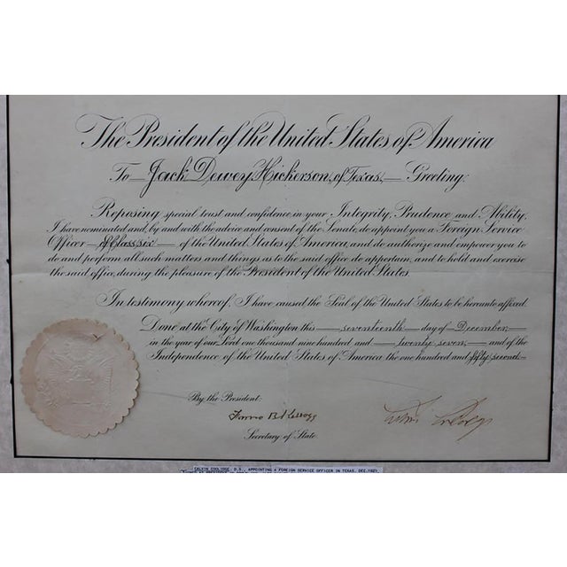 Signed document signed by Calvin Coolidge with an attached president seal. There is a photo of Calvin Coolidge on top of...