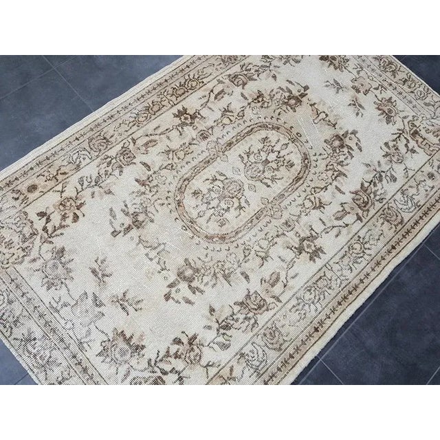 This is a vintage Turkish Oushak rug from the 1960s. The piece was hand-knotted.