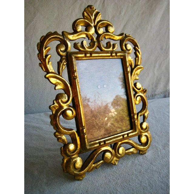 This frame is gilded with gold leaves the traditional way , it is carve wood ,very ornate and elegantly done , nice size...