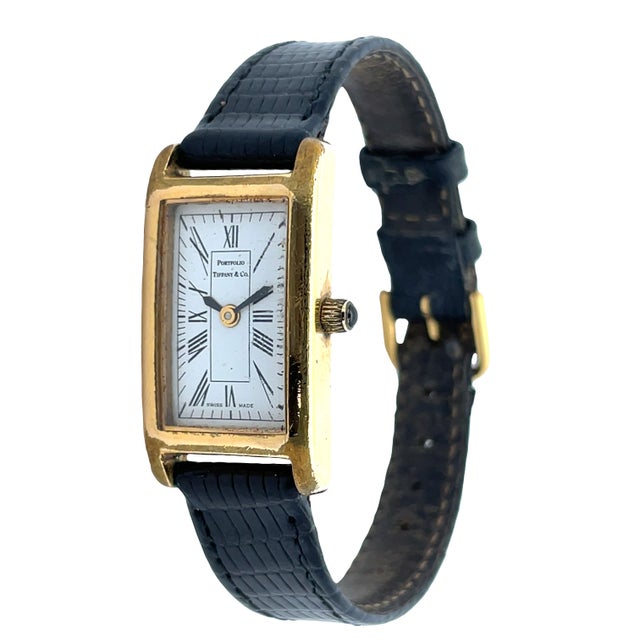 Elegant vintage Tiffany & Co. Portfolio ladies wristwatch featuring a rectangular gold-plated case with classic Roman...
