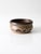 This vintage studio pottery bowl, signed and dated 1984, features an earthy brown glaze with a mottled finish and dark...