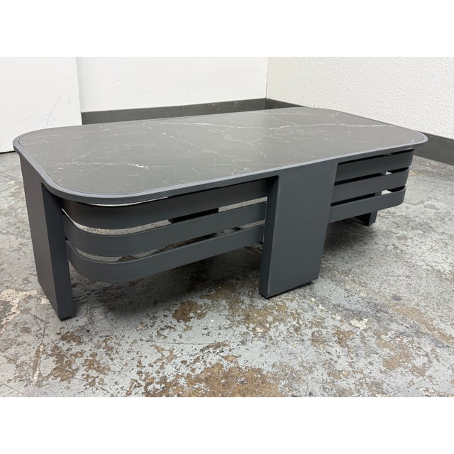 Design Plus Gallery presents the Ari Sintered Stone + Aluminum Outdoor Coffee Table from AllModern. This contemporary...