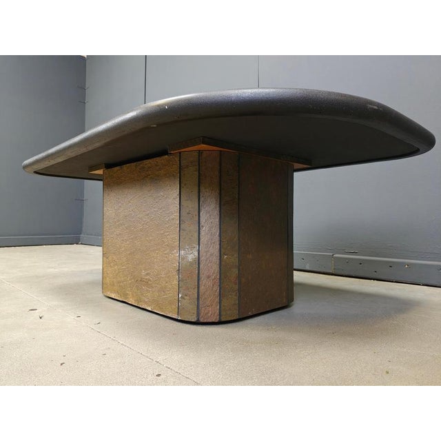 Brutalist slate and natural stone top coffee table with inlaid copper and brass. Black wooden base. The table is signed...