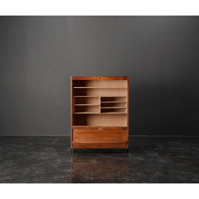 This Art Deco filing cabinet from the 1930s combines practical functionality with timeless design. Its tambour door...