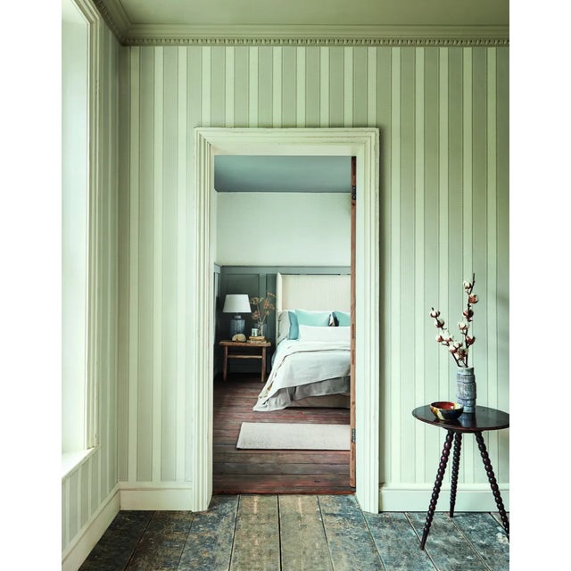 A decorative braid adds detail to this smart stripe wallpaper that’s surface printed to give a textural hand crafted look....