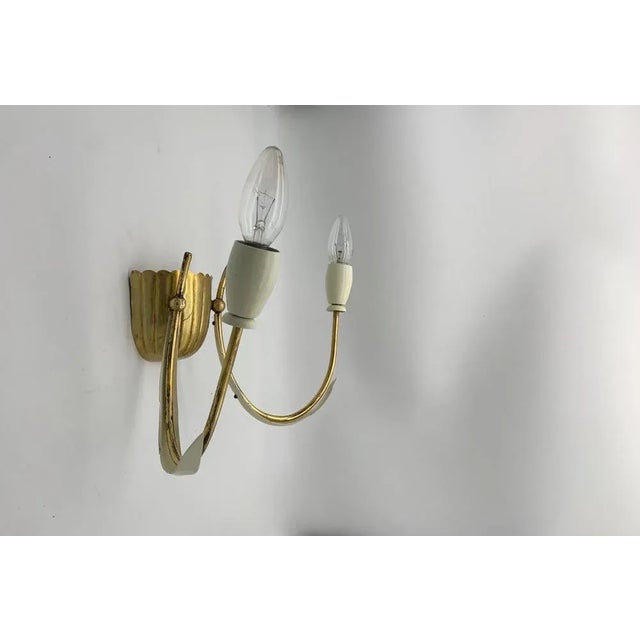 Pair of wall sconces attributed to Stilnovo. The structure is in brass and iron. They were stock funds so never used. We...