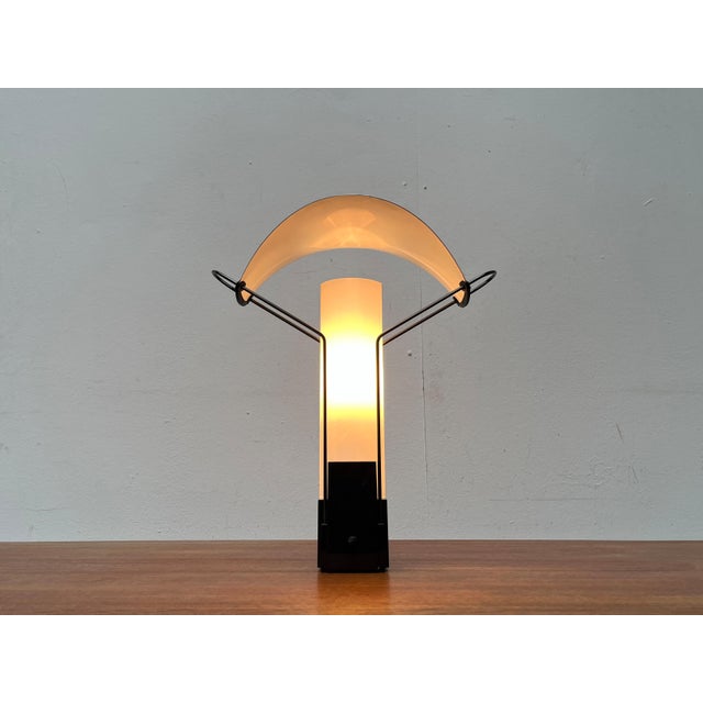 Rare table lamp from the Italian manufacturer Arteluce. A draft in postmodern formal language. Filigree hangers wear a...