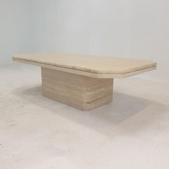 Stunning Italian coffee table handcrafted out of travertine, 1980s. The beautiful rectangle top is rounded on the edge. It...