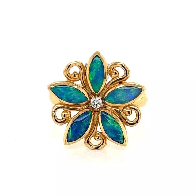 This is a lovely ring by Kabana, crafted from 14k yellow gold featuring a 5 petals star like flower with small gold scroll...