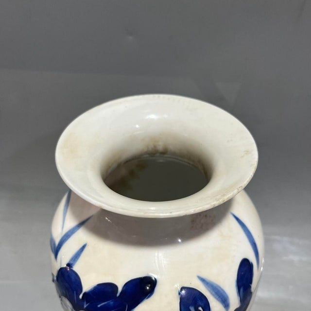 Beautiful Chinese porcelain vase with raised relief blue lotus flowers and foliage. Deep cobalt blue blooms stand...