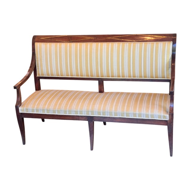 A well-proportioned Empire settee with a crest rail inlaid with a diamond and stringing pattern in contrasting wood. The...