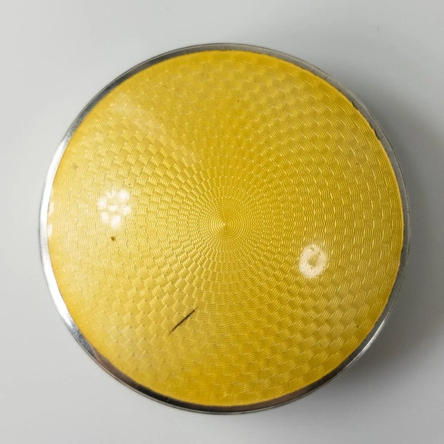 We are selling this pretty yellow guilloche enameled sterling silver American compact, it is marked on the side but we...