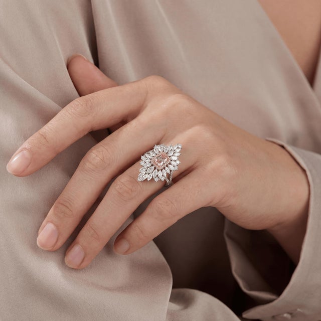 Discover the exquisite elegance of our Flower Shape Cocktail Ring, featuring a Stunning Emerald cut diamond at its center,...
