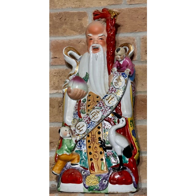 Richly detailed trio of Fu (Fortune), Lu (Prosperity), and Shou (Longevity) porcelain figures in vibrant robes with gold...