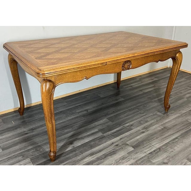 This refined Vintage French Louis extendable dining table is a beautifully crafted piece, featuring an elegant oak wood...