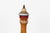 Vintage Italian wooden pepper mill in the Alpine folk art tradition, with a cluster of hand-painted flowers, accented by...