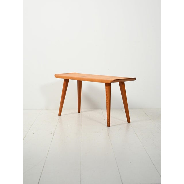 Swedish pine bench, model "Visingsö," featuring soft lines and light proportions, with exposed construction details. This...