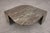 A sculptural stone coffee table, dating from the late 20th century, featuring an elegant eye-shaped top carved from richly...