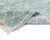 A fine diamond trellis in teal fades gently into pale sage, as though the pattern itself were dissolving into mist across...