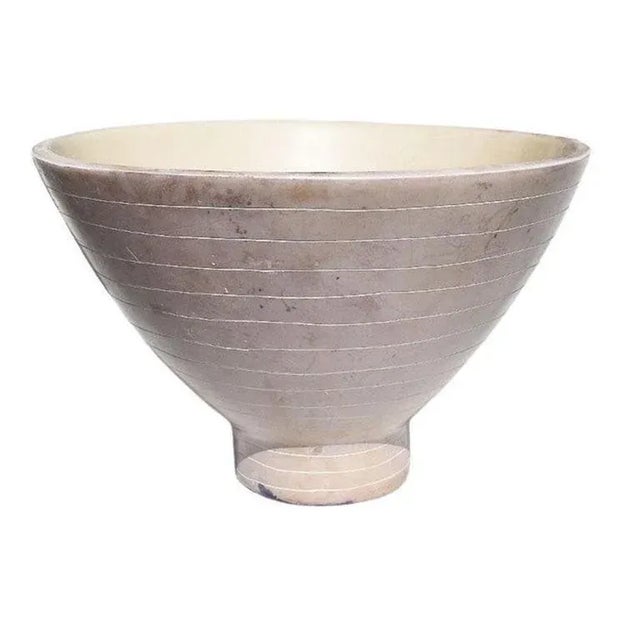 A heavy decorative stoneware bowl in pale purple. This bowl will be fabulous sitting on a coffee table, in a kitchen...