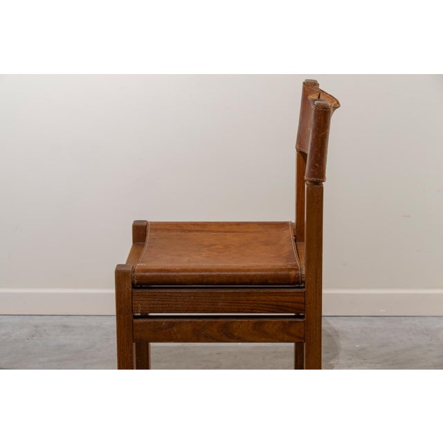 Pair of rationalist chairs crafted from oak with cognac-colored leather seats and backs. Narrow leather backrest, screwed...