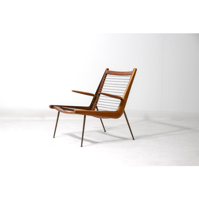 Lounge chair designed by Peter Hvidt and Orla Møgaard-Nielsen during the 1950s in Denmark. The frame is constructed from...