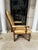 Upholstered in a golden tan color leather with a contrasting fabric upholstered back. This chair also have a nail hand...