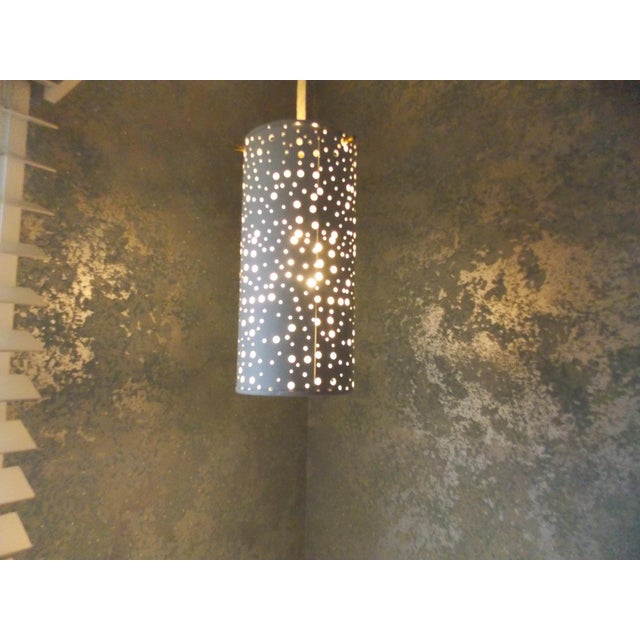 Pair of Art Deco hanging Lights designed by Ernest IgL. Pierced, white, painted lacquered metal cylindrical hanging lights...