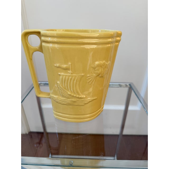 This striking Art Deco pitcher by Robinson Ransbottom Pottery Co. (RRP Co.) features the "Zephyrus" pattern, depicting the...