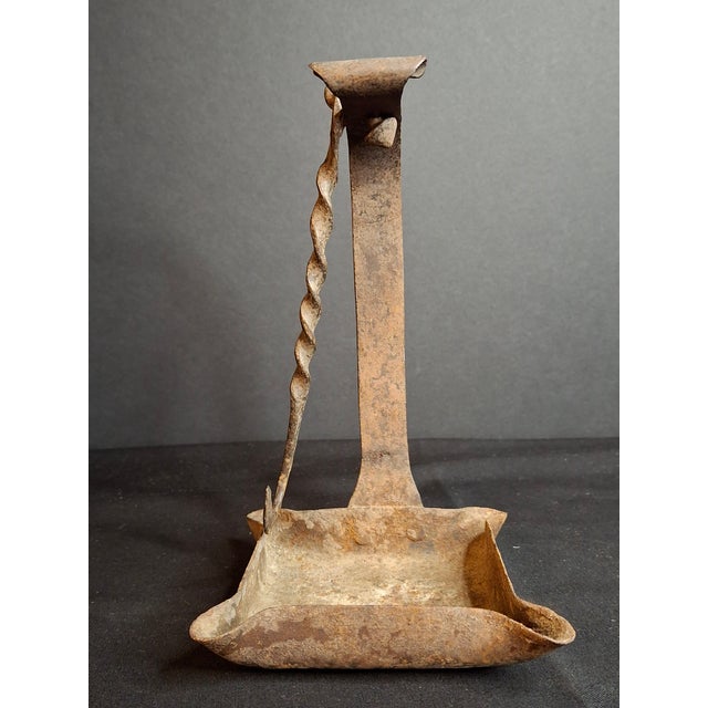 An exceptional late 18th to early 19th-century hand-forged wrought iron four-wick open grease/fat lamp (often referred to...