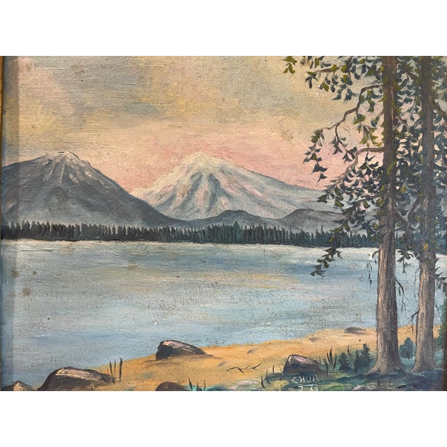 This is a lovely mountain landscape painted on board in its original gold frame. Signed and dated at the bottom “Chub 2.39”