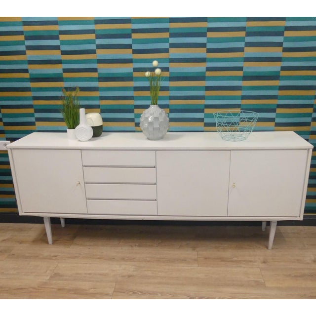 XL Sideboard! Compact and sturdy Panton-era style in (cream) white Timelessly stylish Four drawers, three doors—each with...