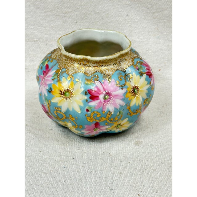 Antique Royal Kinran Nippon hand painted bowl decorated with flowers on a pale blue background with raised gold decoration...