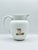This vintage Napcoware “Athena” C-8603 pitcher offers timeless neoclassical beauty in hand-painted bisque porcelain....