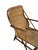 Vintage rattan chaise lounge dating to the 1970s. The piece features a sculptural bent rattan frame with integrated arms...