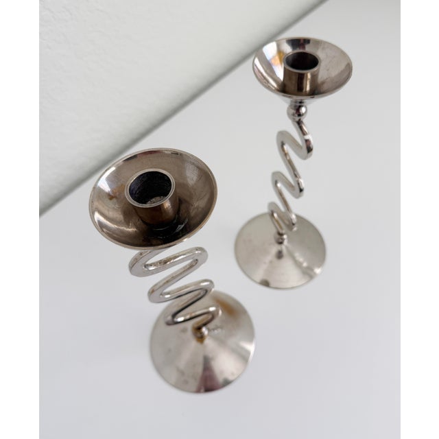 A pair of Postmodern, Memphis Style taper candle holders featuring a zig zag or squiggle design. Made of brass, finished...