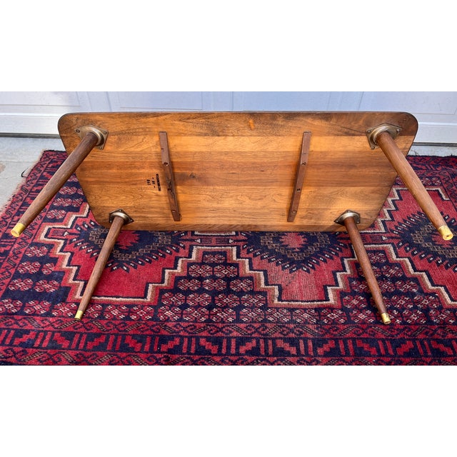Perfectly sized walnut and brass Mid-Century Modern coffee table. It has been restored to it's original glory.