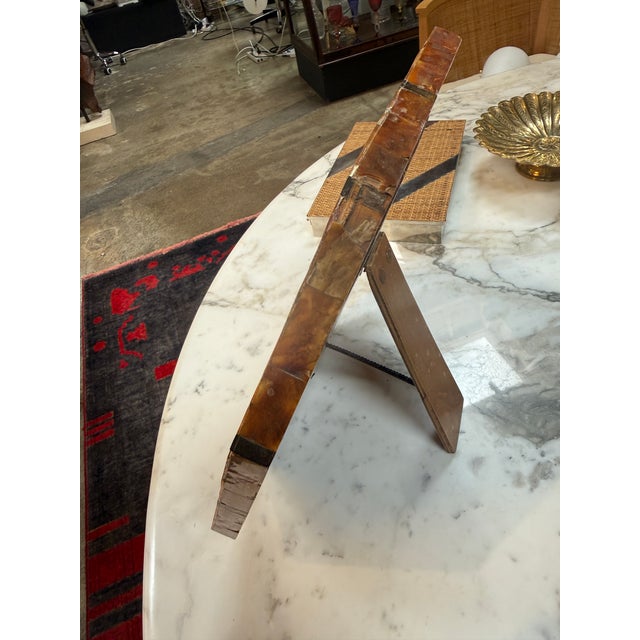 Striking vintage picture frame handcrafted from amber-toned shell inlay and intersecting brass bands. Its sculptural...