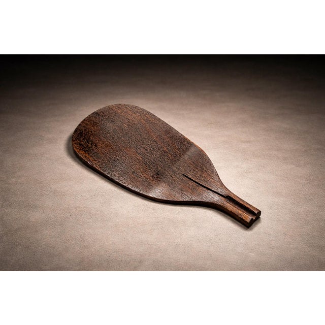 Attributed to a Brazilian workshop, circa 1960s, this rosewood (jacarandá) serving platter reflects the restrained...