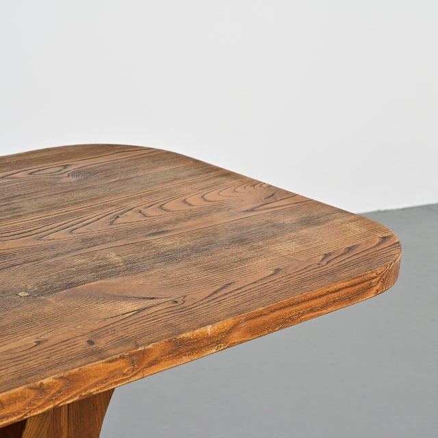 Dining table made in the French Alps around 1970. The rectangular tabletop with rounded ends is made of solid wood,...
