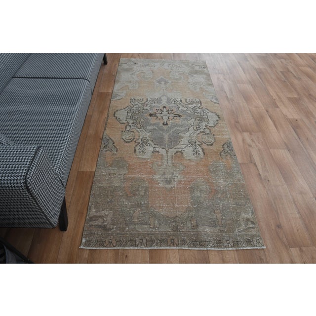 Vintage Hand-Knotted runner rug is a semi-antique vintage area rug. The '70s Eastern region of Anatolia's unique rug is...