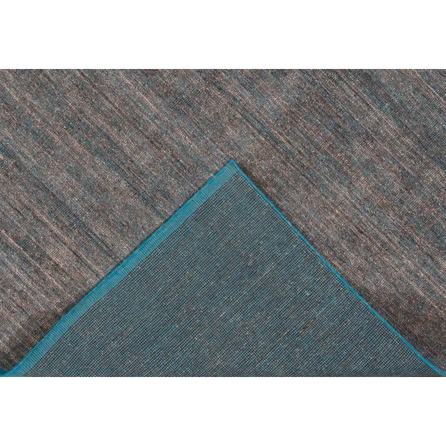 Beautiful modern Indian Boho-Style hand-knotted wool rug with a gray field. This piece has silver and teal accents in an...