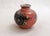 Small Art Deco vase, rounded body and small cylindrical neck with a silver rim, speckled pink background and stylized...
