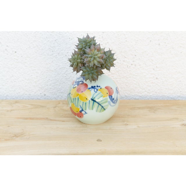 A small vase like this rewards close attention more than a large one ever could. Its round, gourd-like body is hand-...