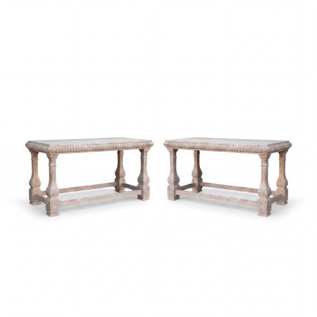 This is a pair of rustic French style cerused and carved console tables with attached marble tops by Baker Furniture...